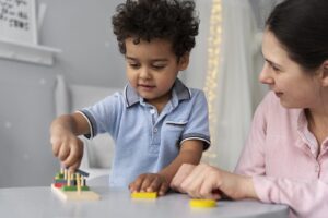 Child and adult playing with a pegboard toy during a therapy session