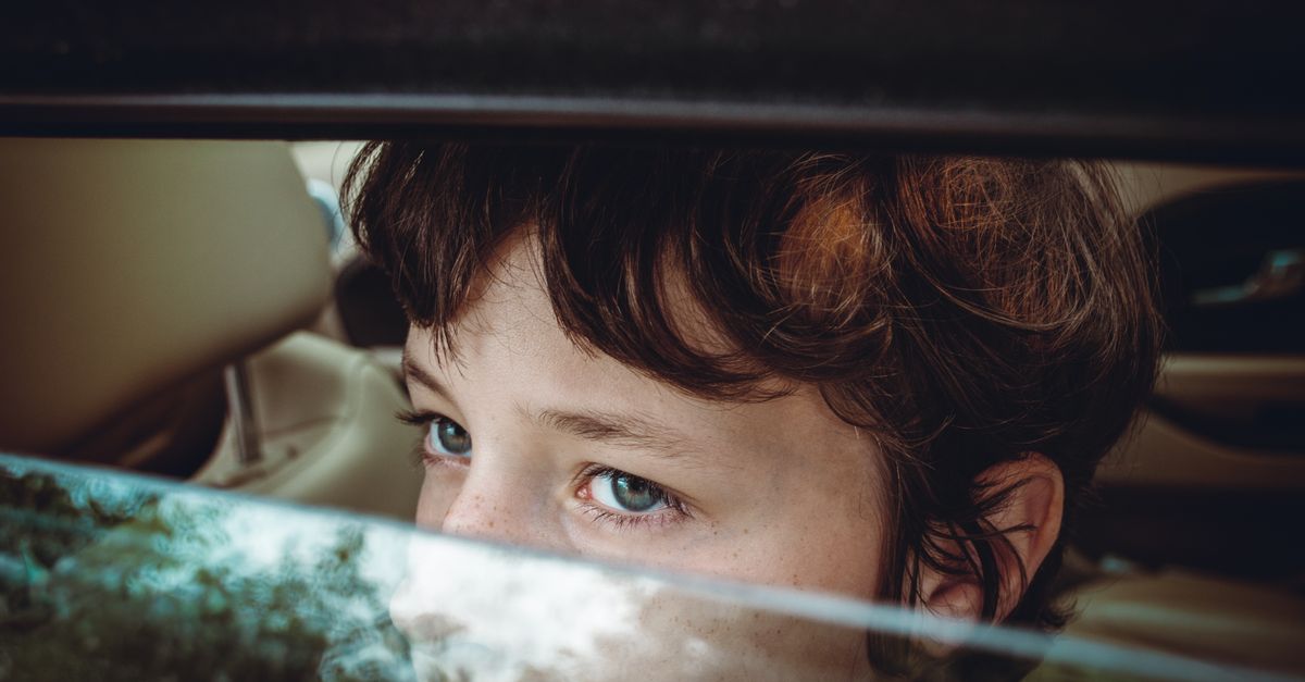 Child sitting alone and withdrawn, reflecting low mood and social disengagement