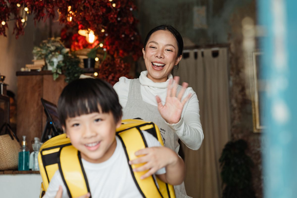 Child leaving for school with confidence while the parent waves goodbye